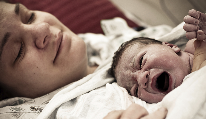 tired woman with newborn
