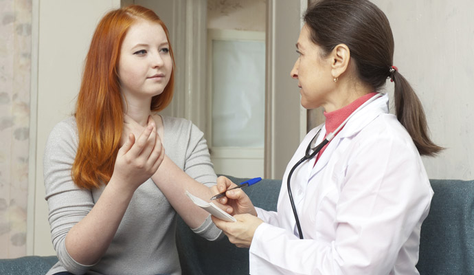 adolescent girl speaking to doctor